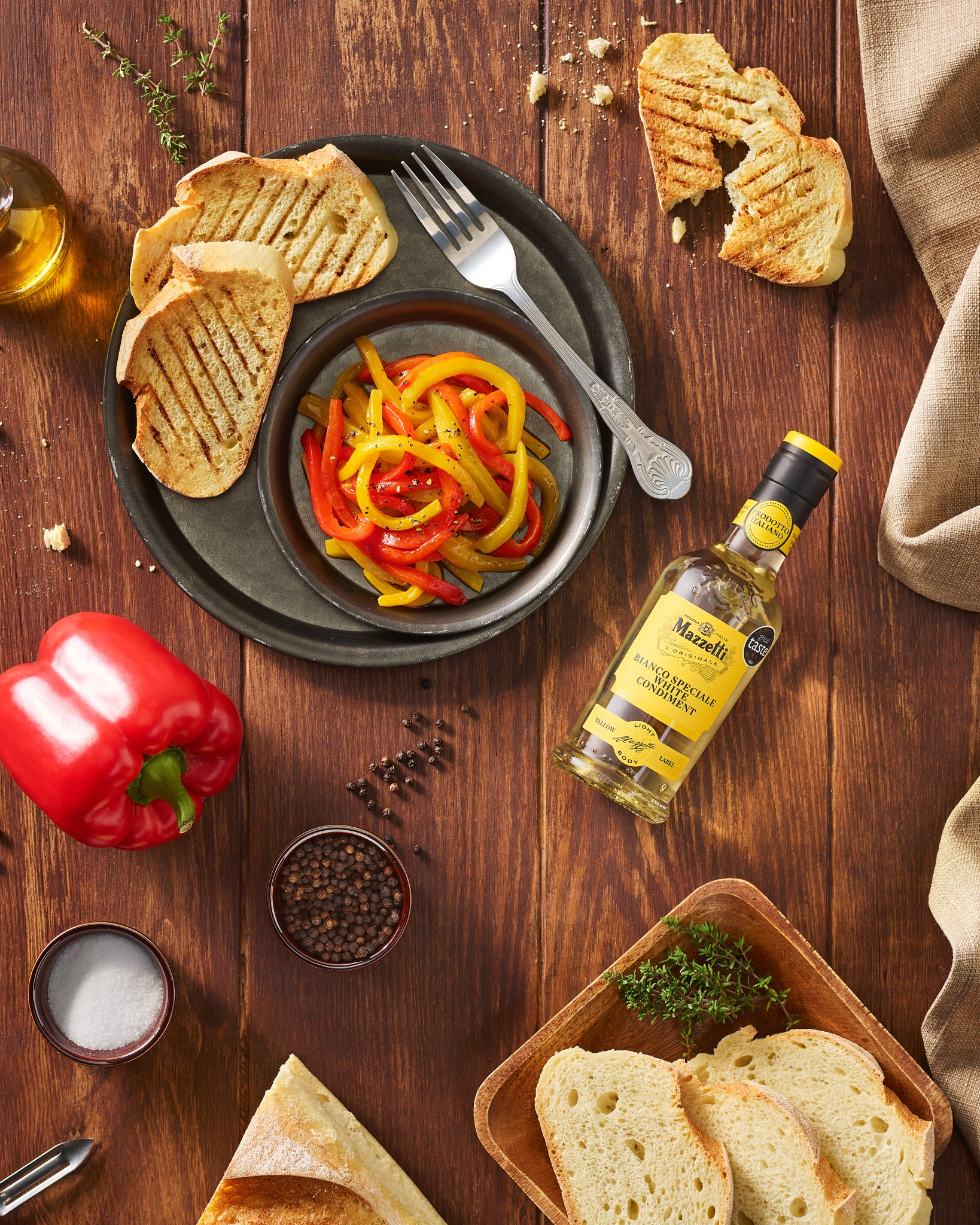 Appetizer of sweet and sour mixed peppers with crusty bread
