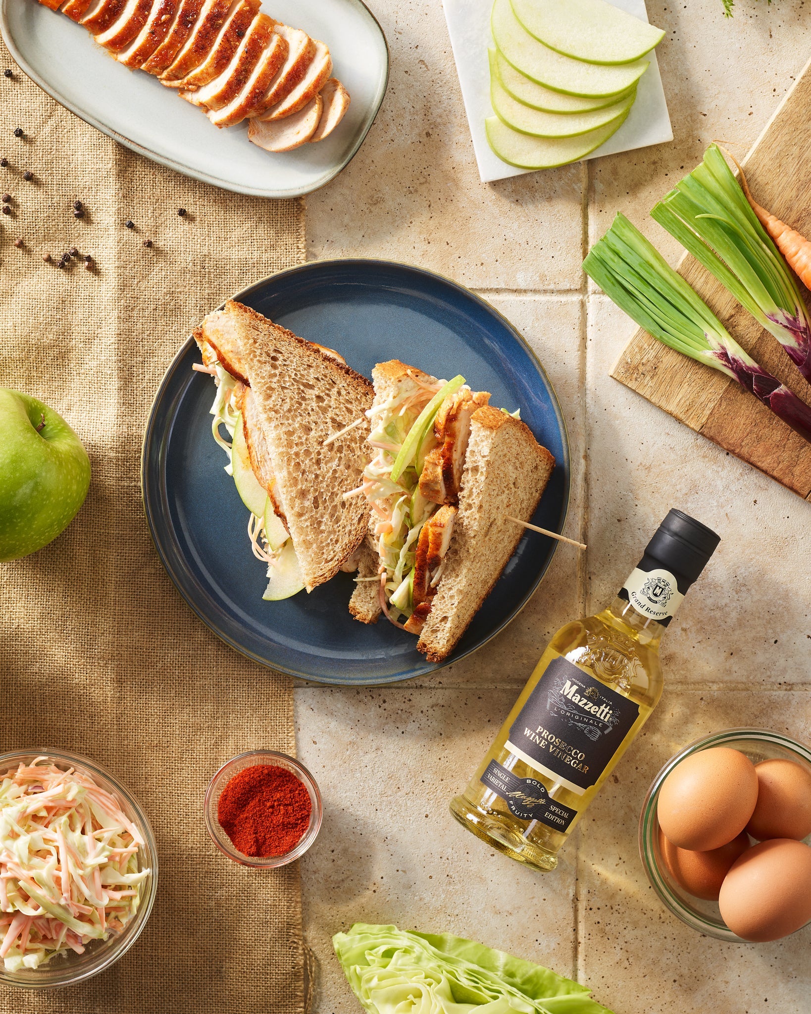 Wholemeal sandwich with sliced chicken, green apple slices and coleslaw with vinegar mayonnaise